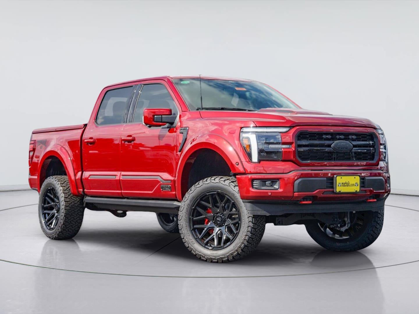 2026 Ford F-150 Lariat TORQUE EDITION in Ruby Red Metallic Tinted Clearcoat — front three-quarter view